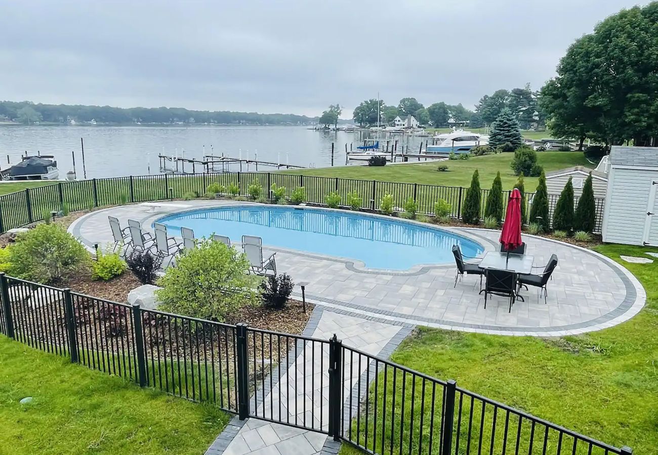 Pool with comfortable seating and umbrellas 