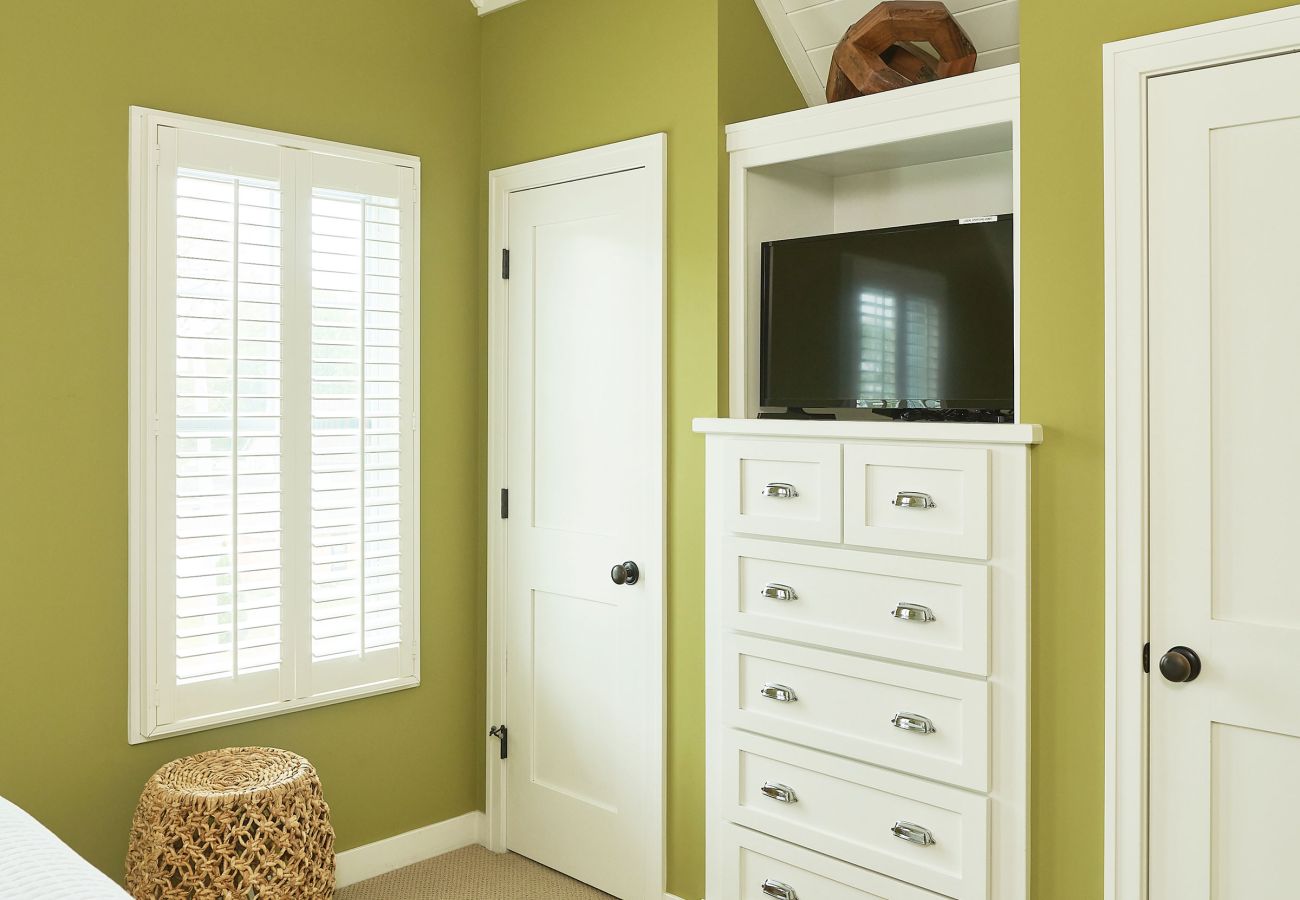 Primary bedroom with walk in closet and drawer space 