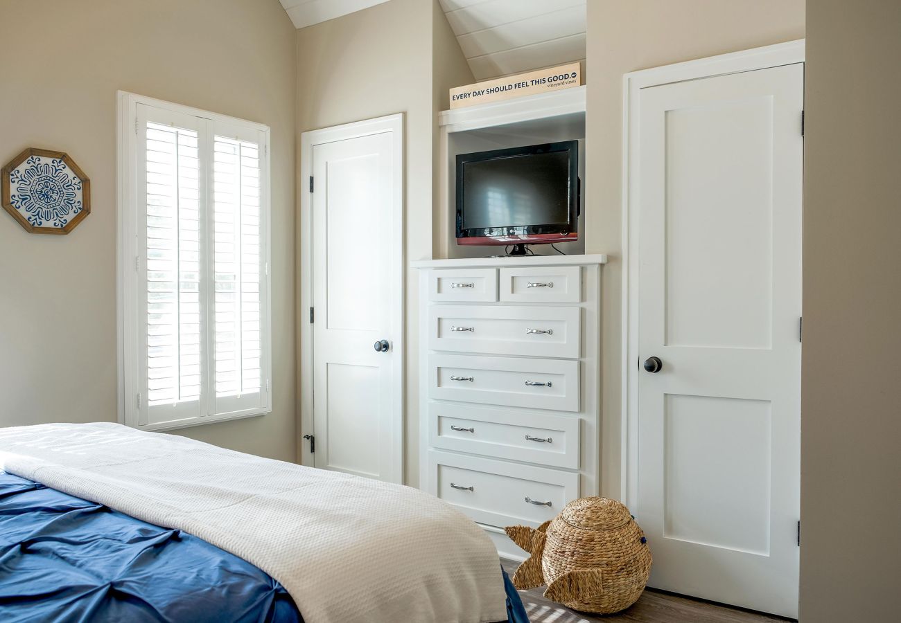 Primary bedroom with entertainment and closet space 