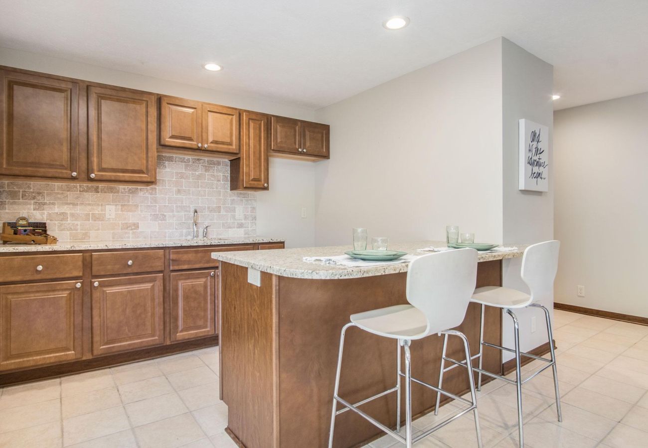 Lower level kitchen with sink and island seating 