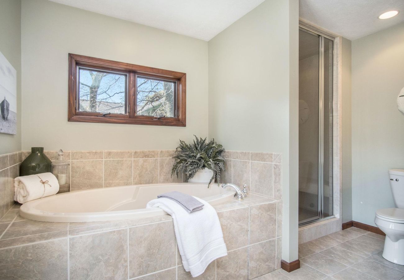 Primary bathroom on second floor with bath tub and shower 