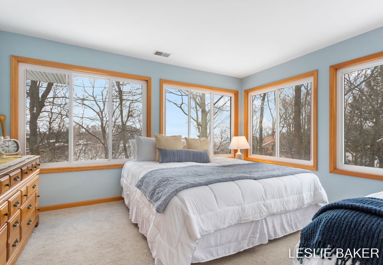 King bed in bedroom with 3 twin beds