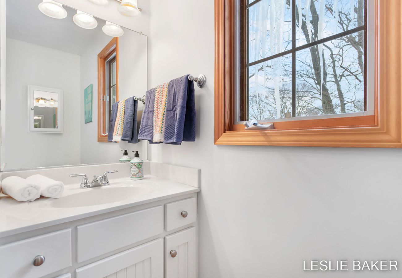 Second floor bathroom includes shower, sink and toilet