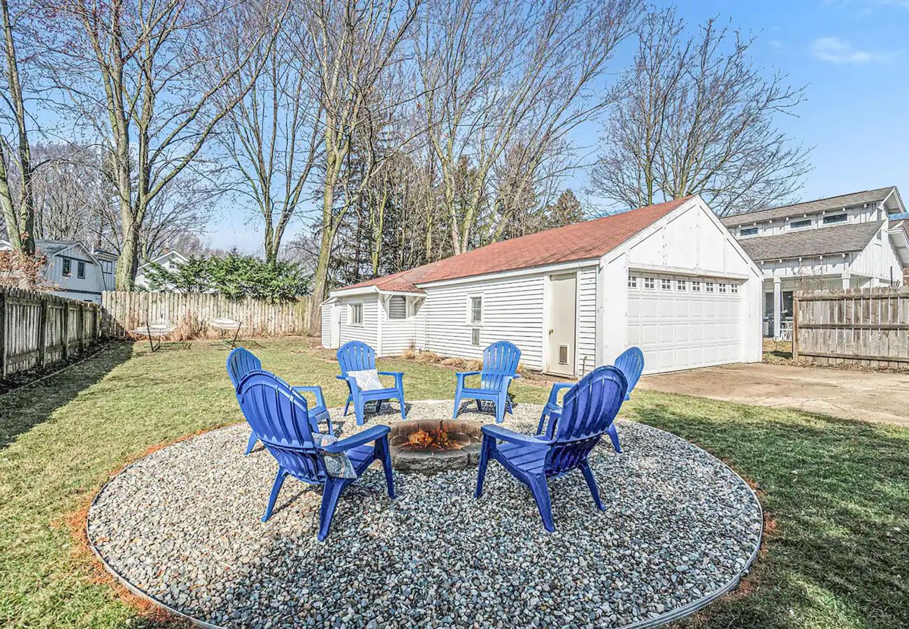 Fire pit and seating area located in the backyard of cottage