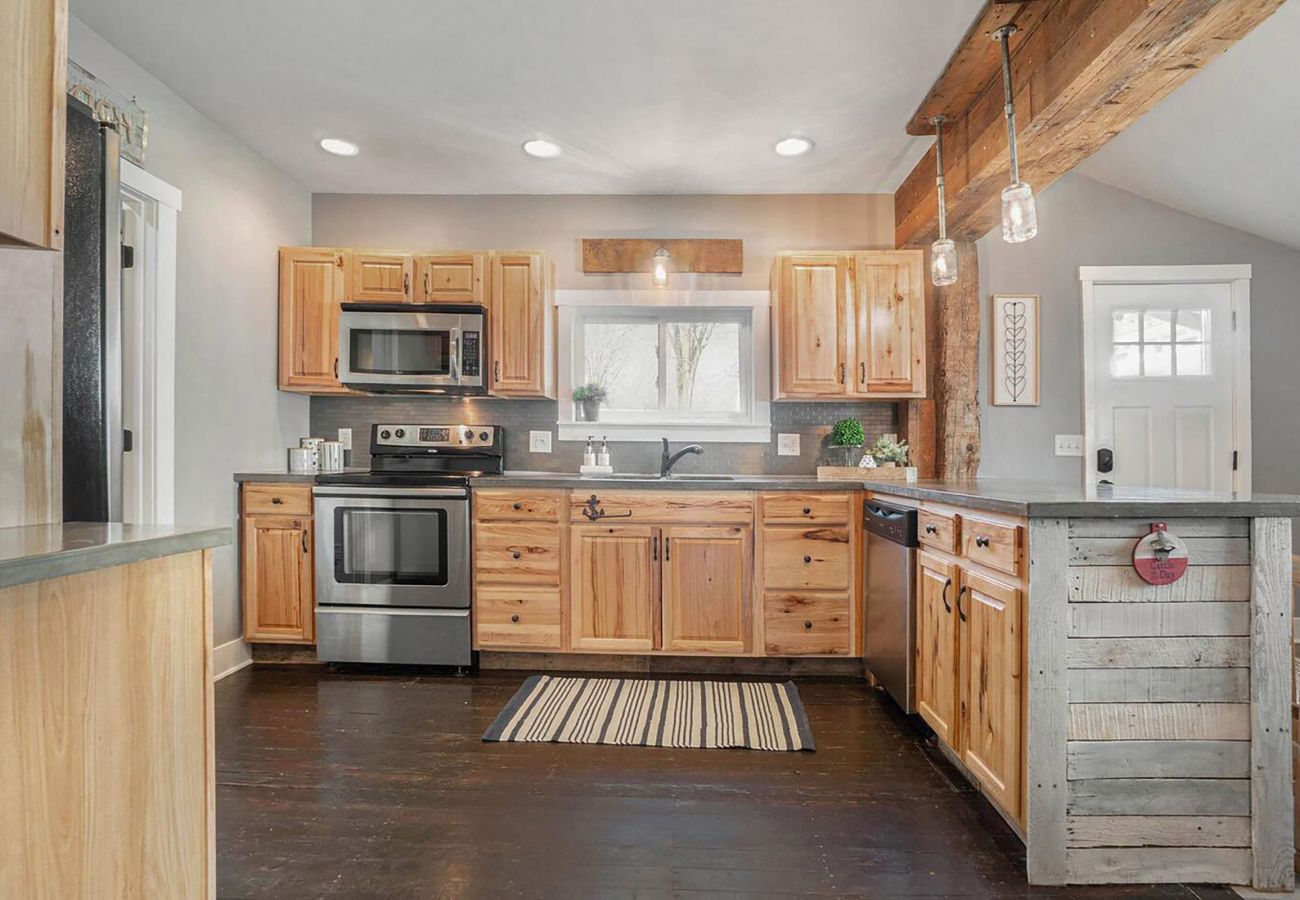 Full kitchen includes microwave, stove, oven, sink and dishwasher 